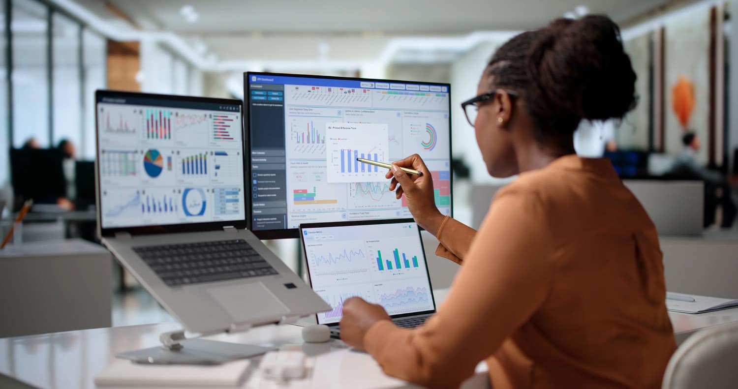 analyst studies laptop financial dashboard