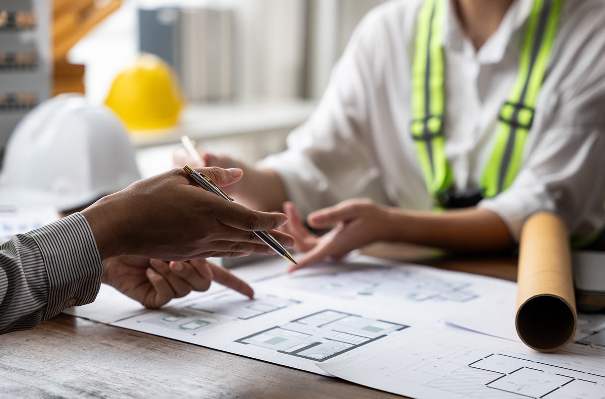 architects engineers checking house blueprint