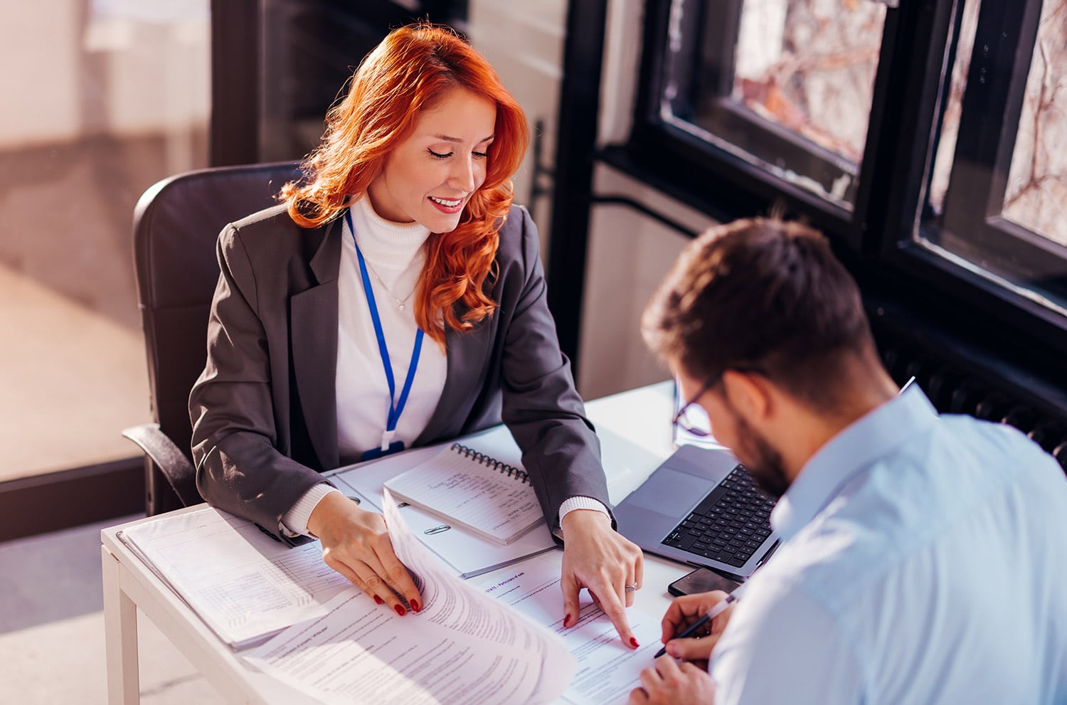 bank account manager talking over contracts with client