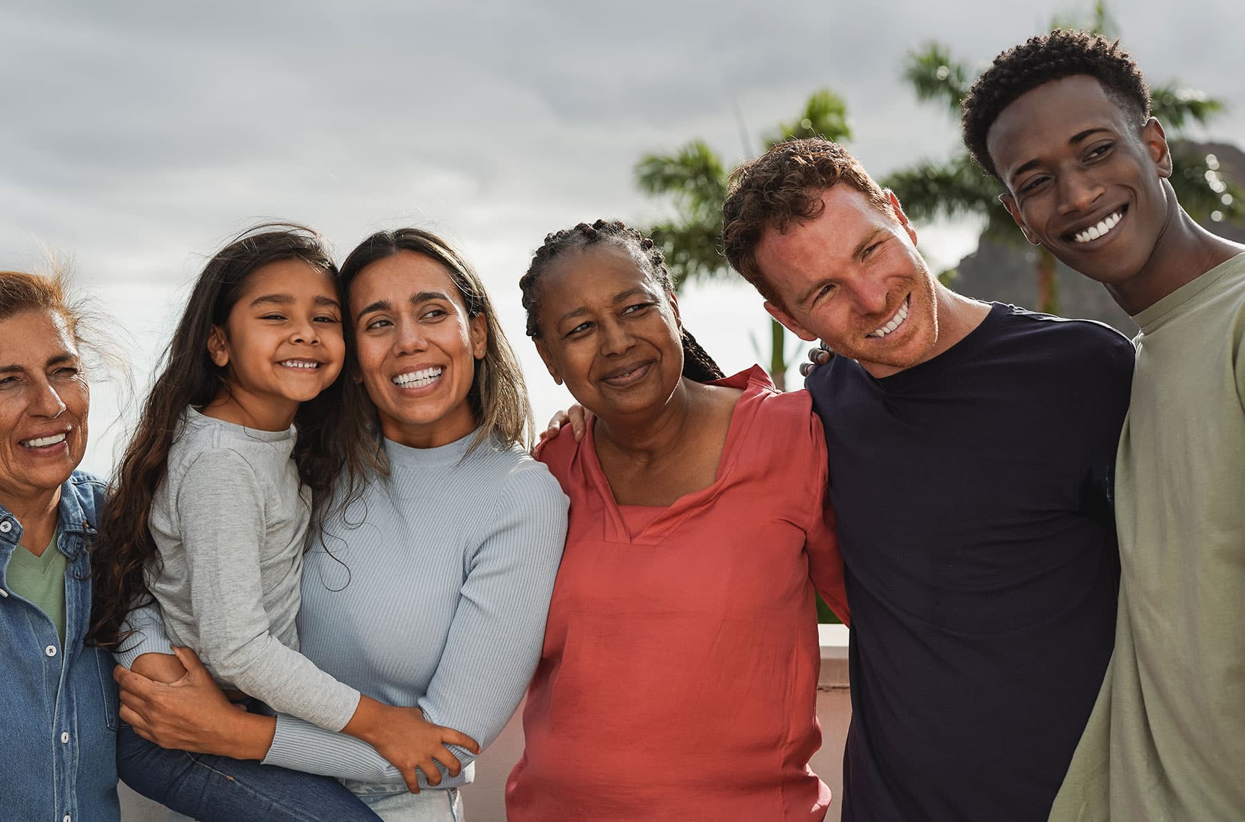 One community smiling with their arms around each other