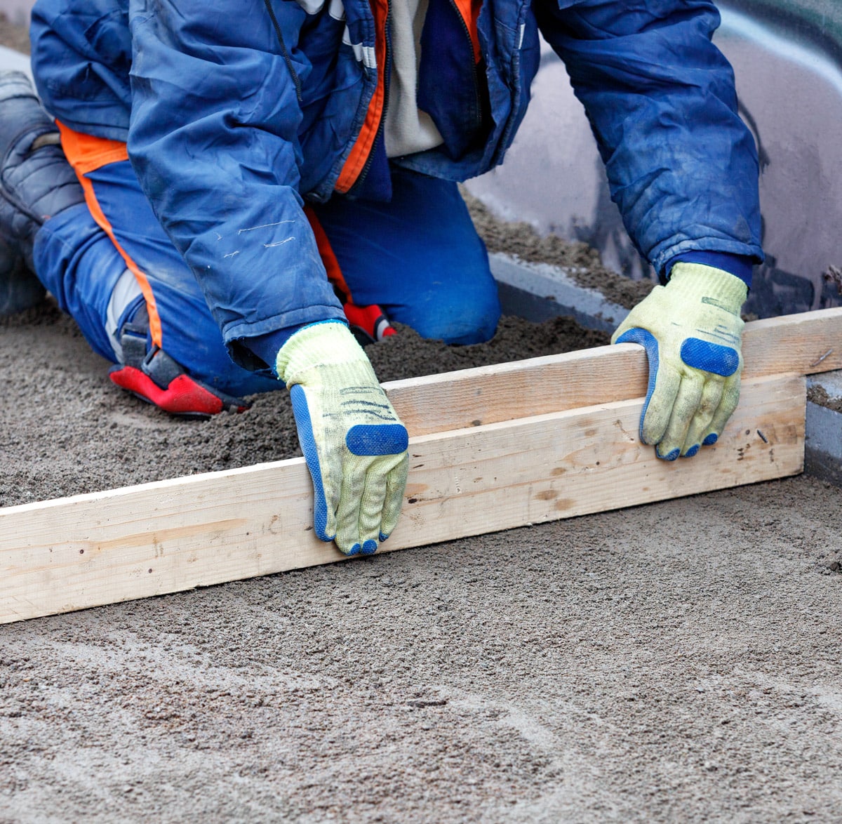 construction worker fixing pavement blocks
