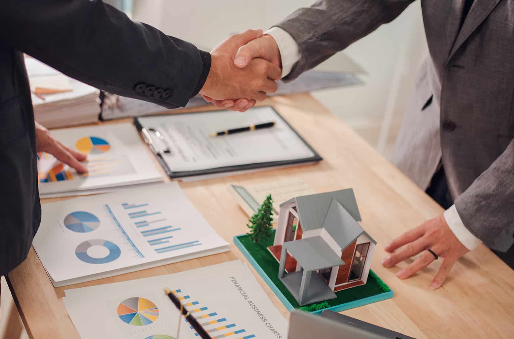 deed manager shaking hands with client
