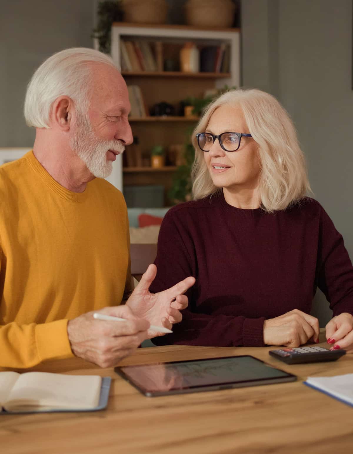 elderly couple talking about financing document