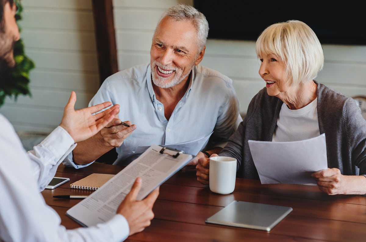 elderly couple talking to community manager