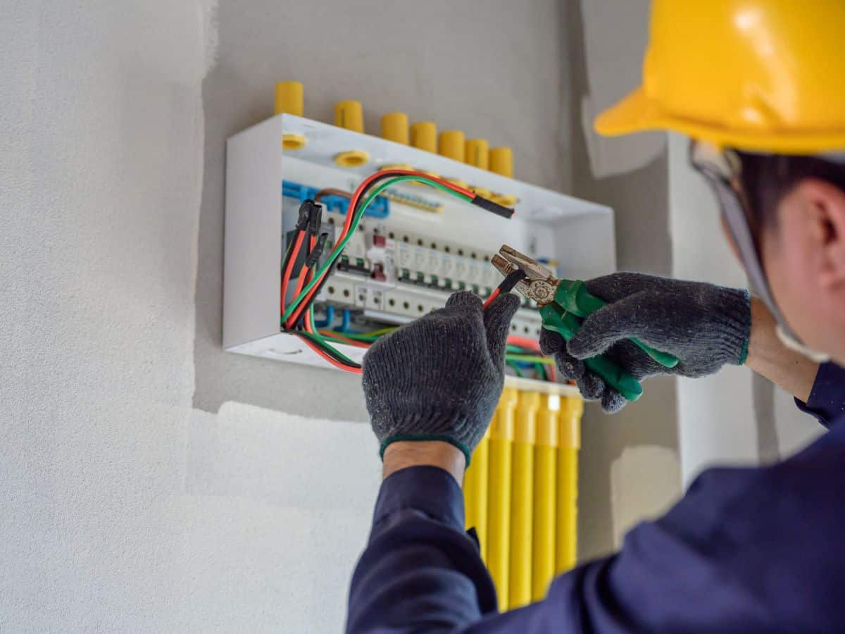 electric maintenance worker checking breaker switch
