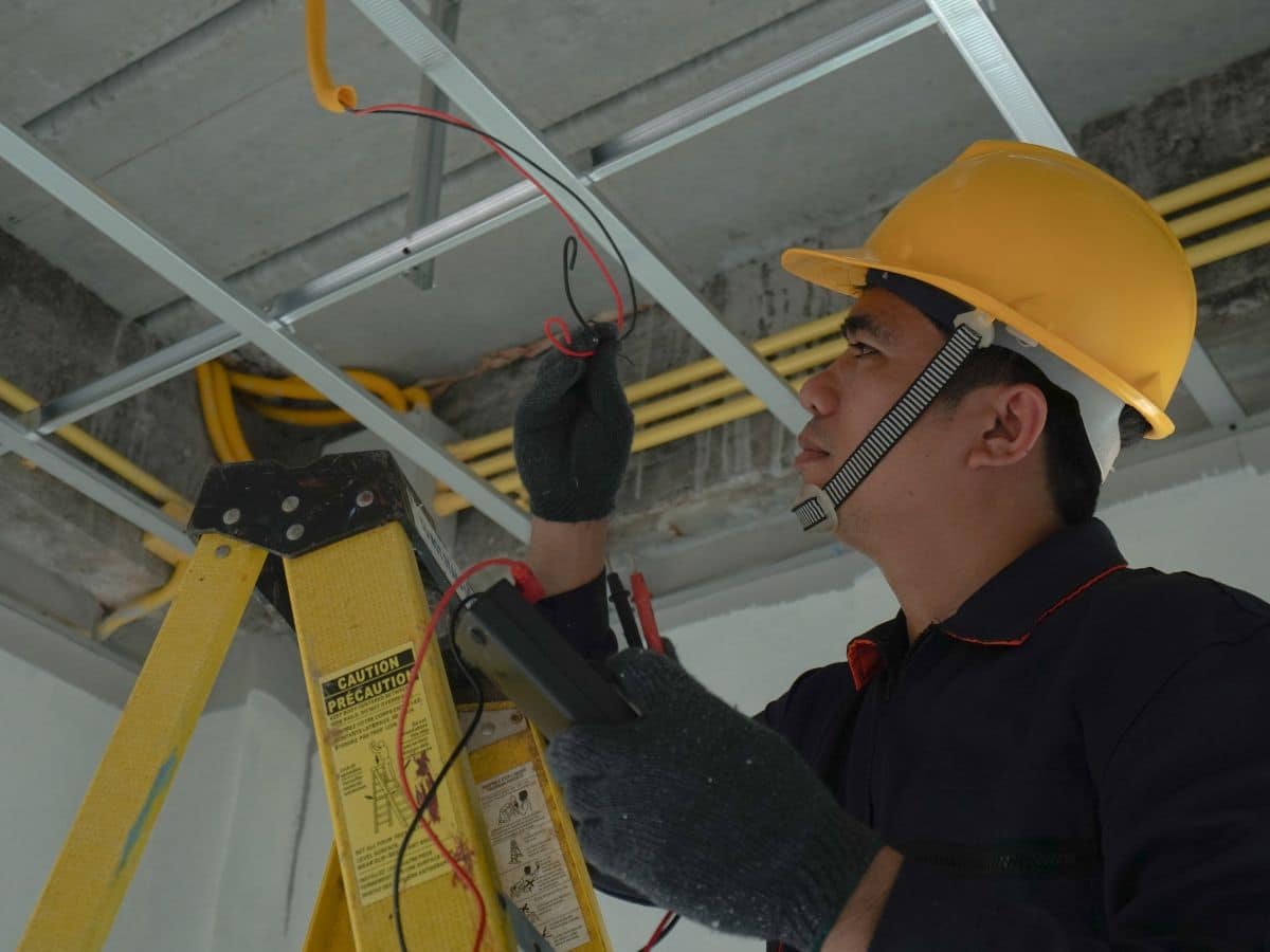 electric maintenance worker fixing lights