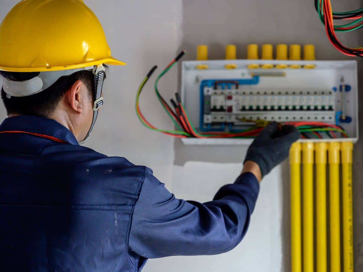 electrical maintenance worker checking breaker