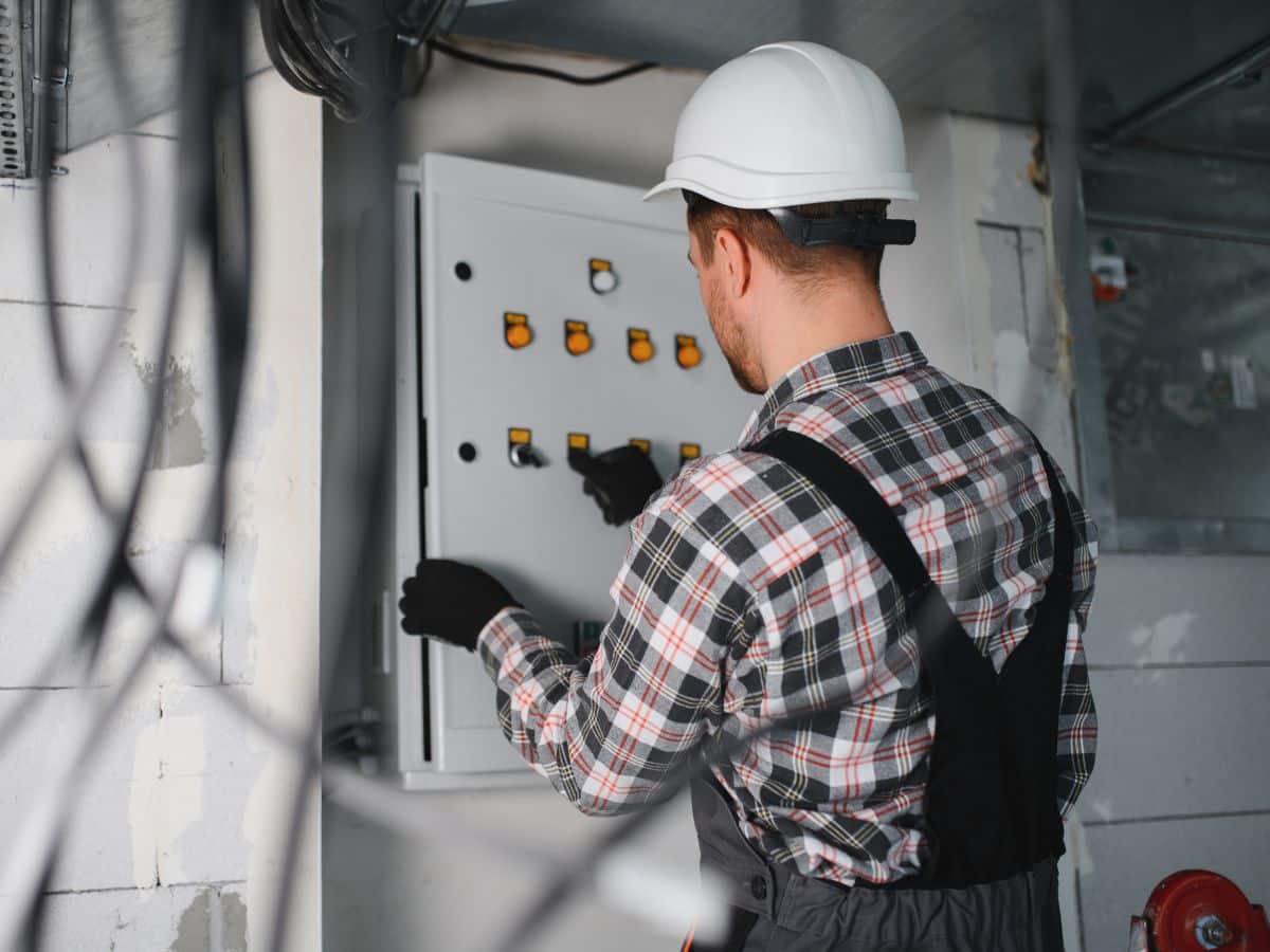 electrical maintenance worker testing electric breaker