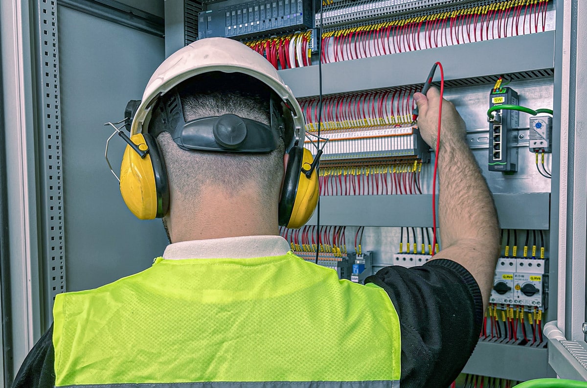electrician checking breaker