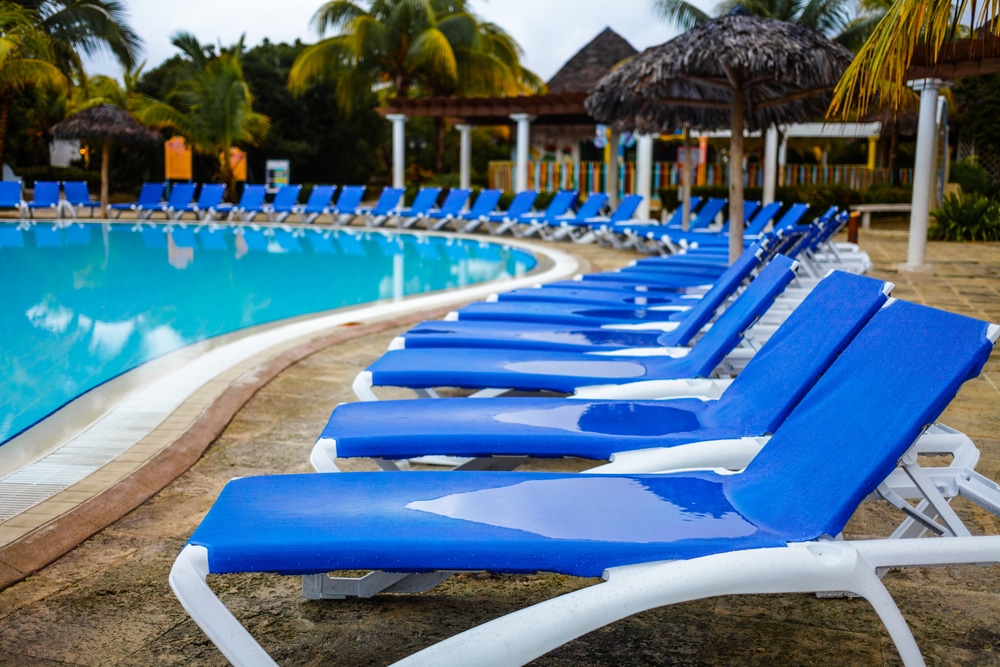 empty resort pool chairs during the morning