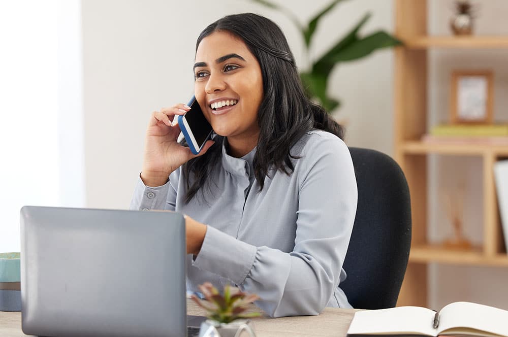 event planner on phone calling to client
