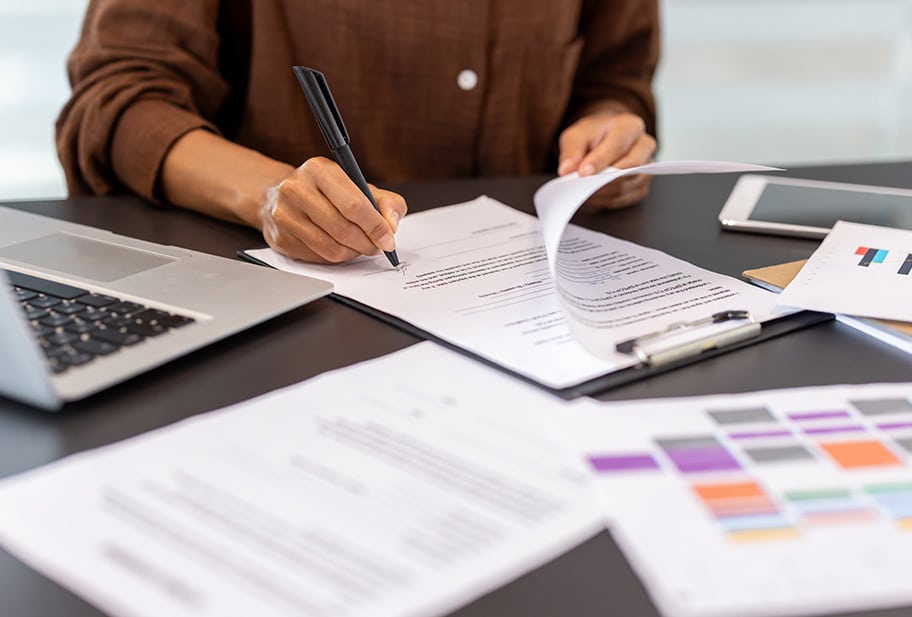 female client signing insurance papers