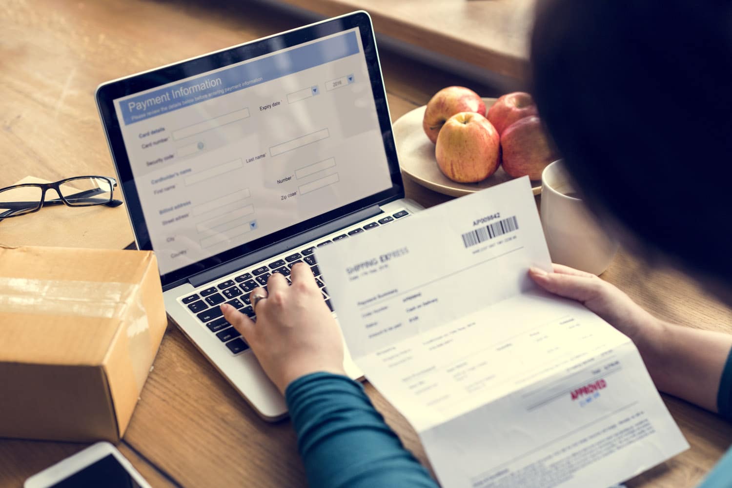 fiduciary processing online vendor payment documents on laptop