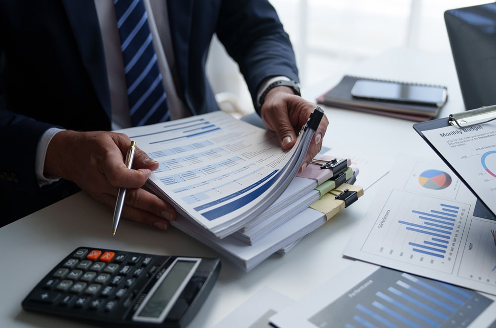 financial manager holding finance reports