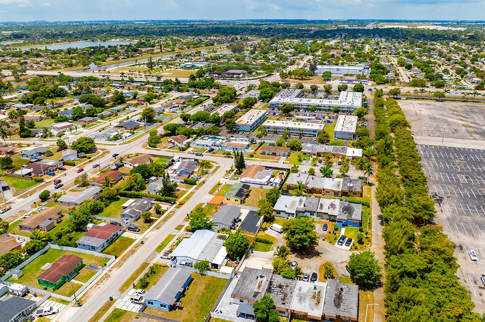 Aerial view of a well-maintained Florida HOA neighborhood with clear street signage