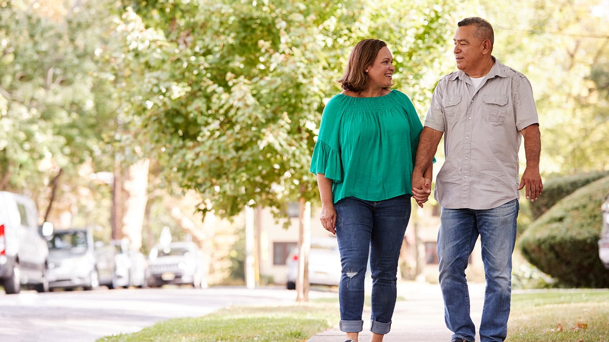 happy couple holding hands in neighborhood