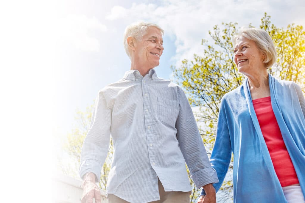 happy elderly couple holding hands