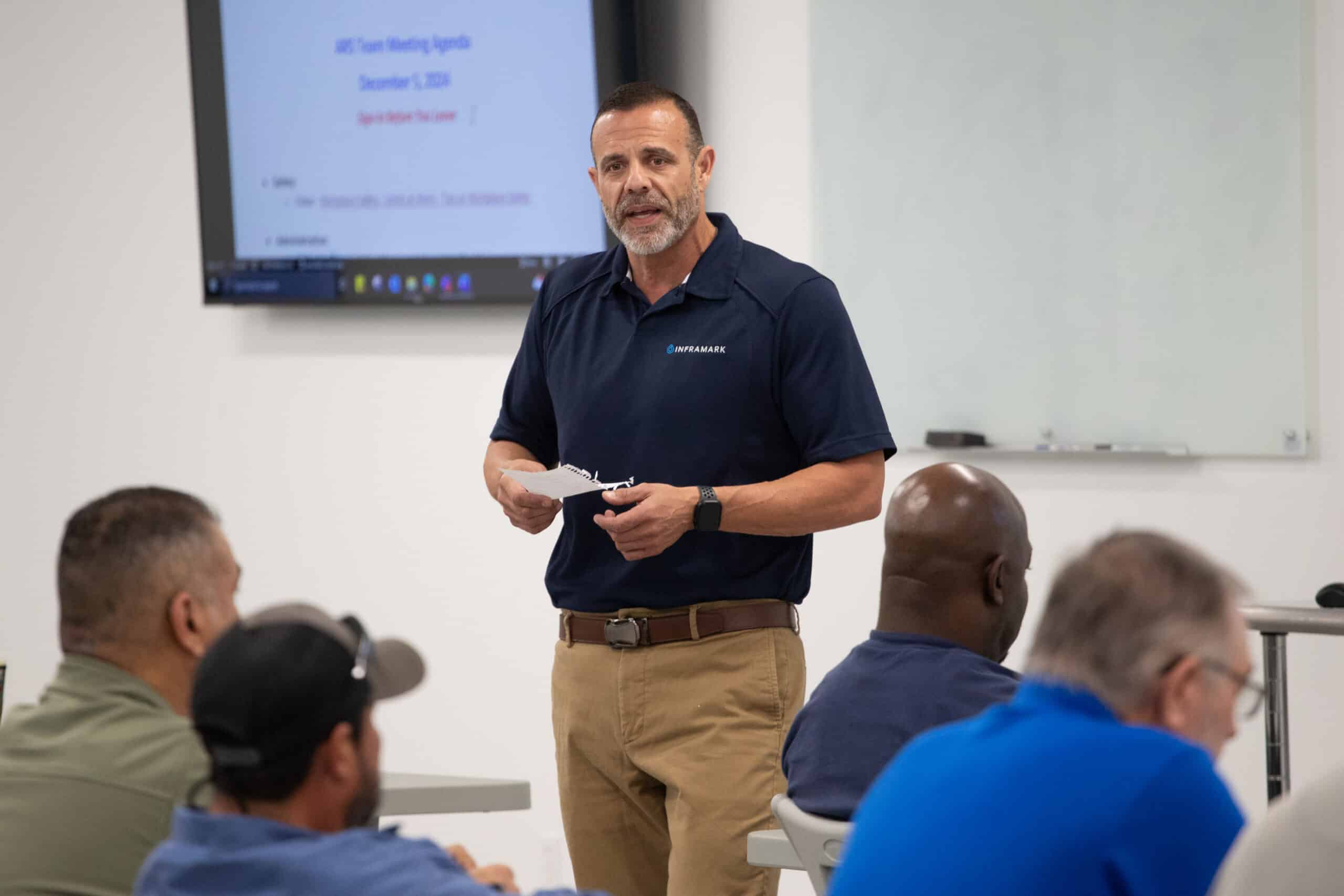 Inframark staff member giving a briefing or presentation to coworkers