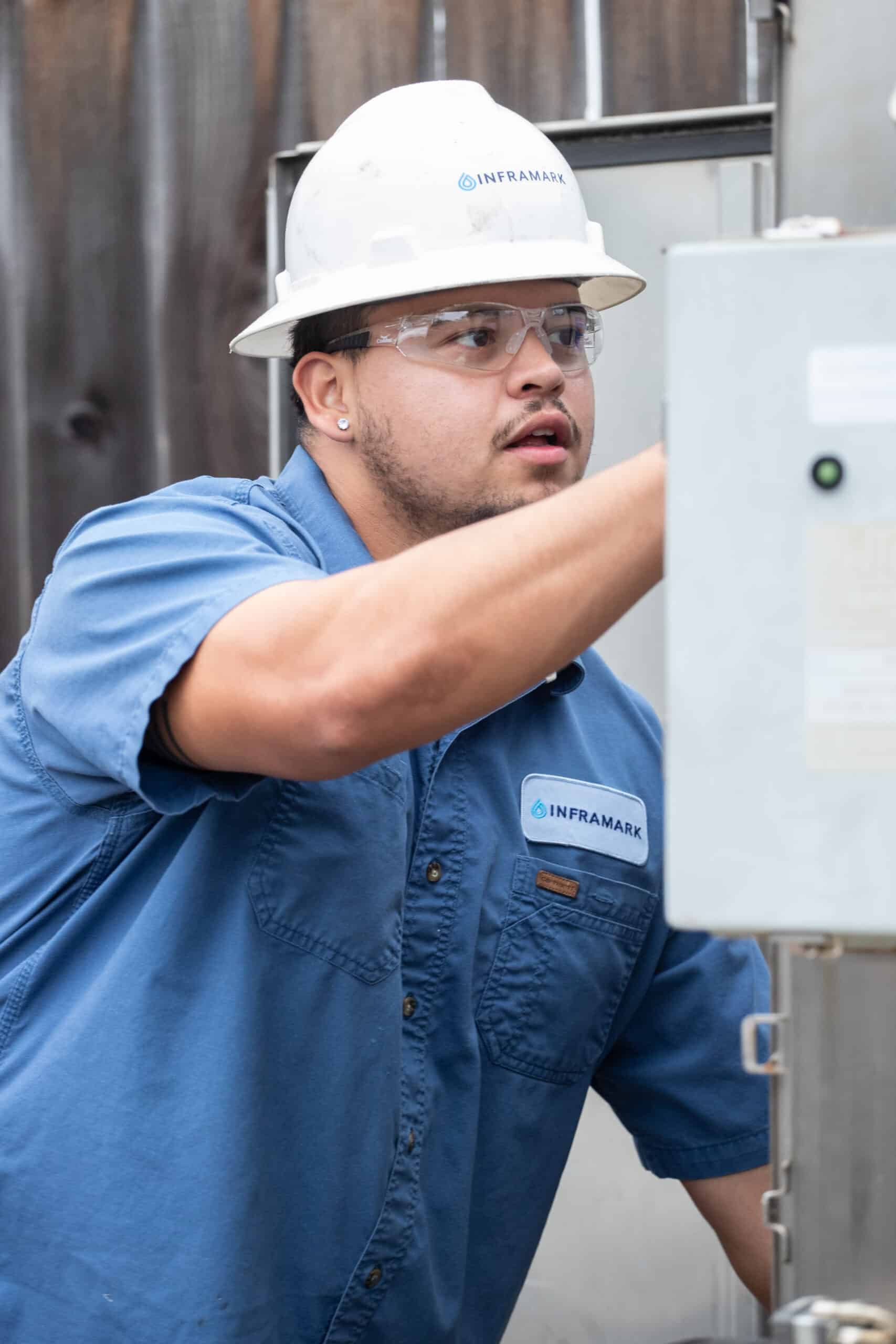 Utility worker from Inframark in safety gear and hard hat