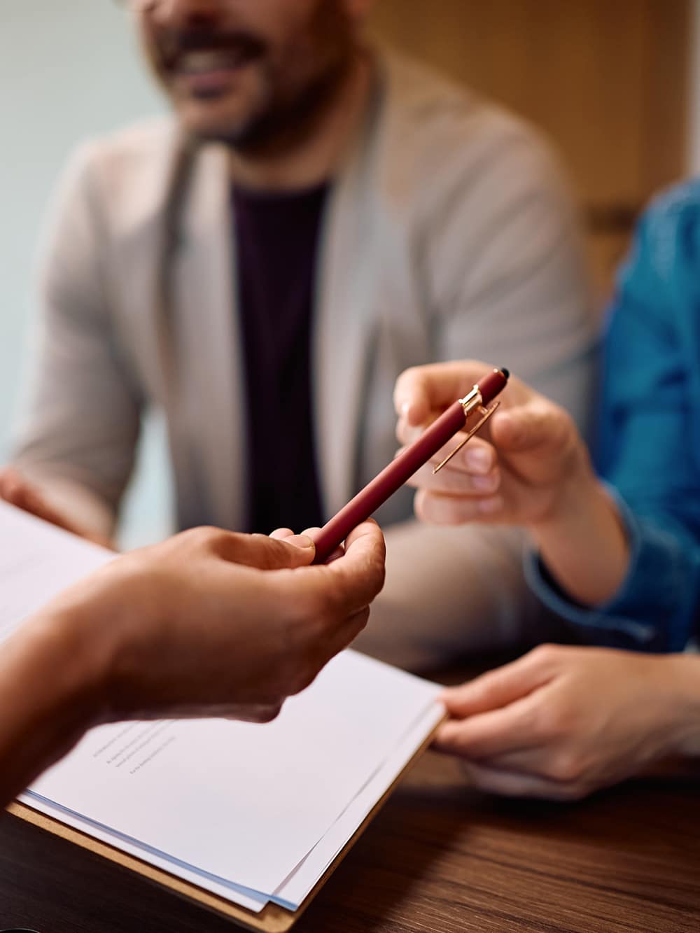 insurance manager handing pen to client