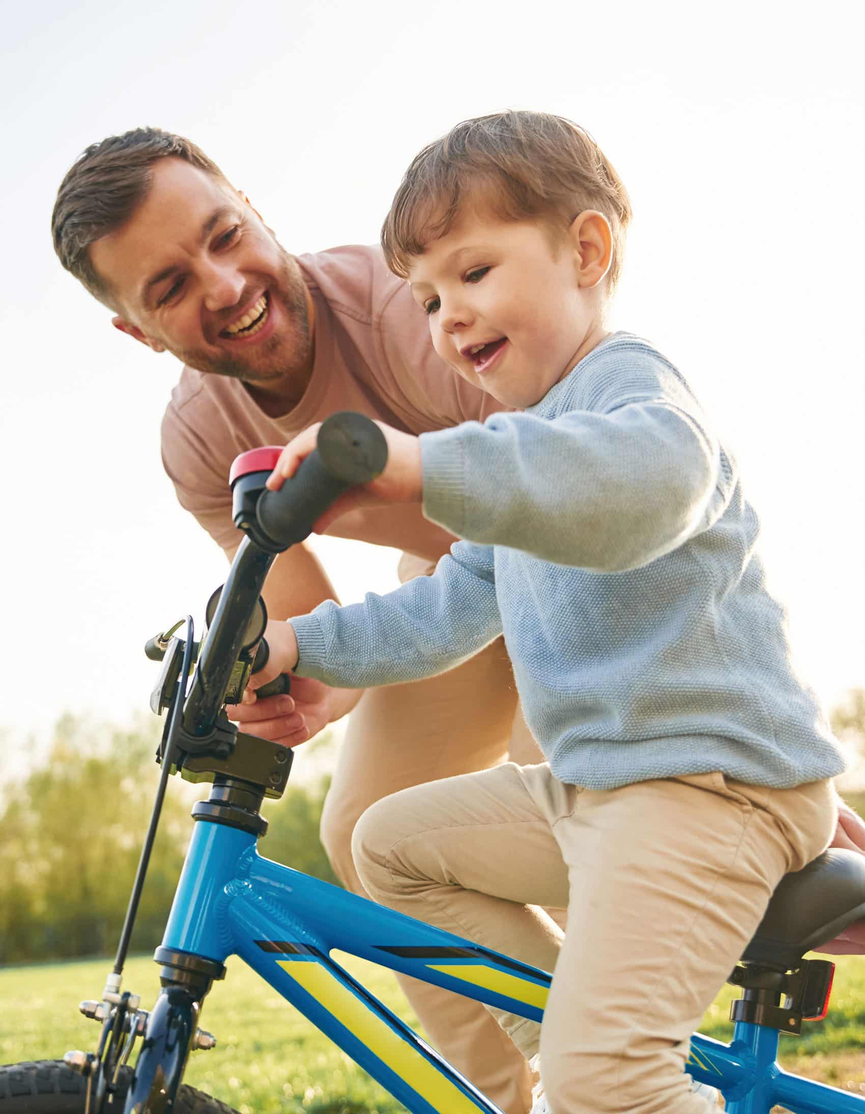 Father Teaching Son How to Ride a Bike
