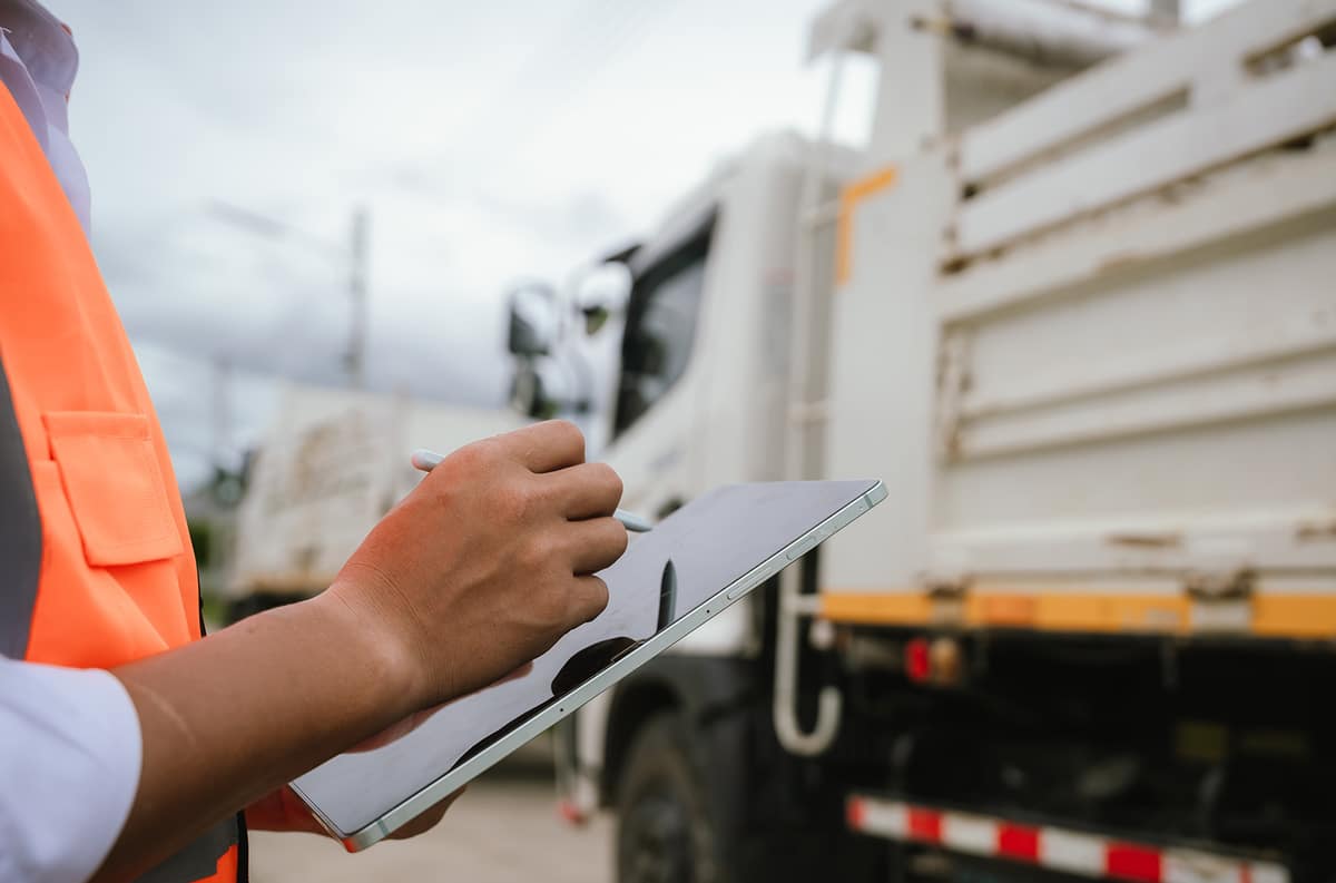 maintenance inspector checking garbage truck