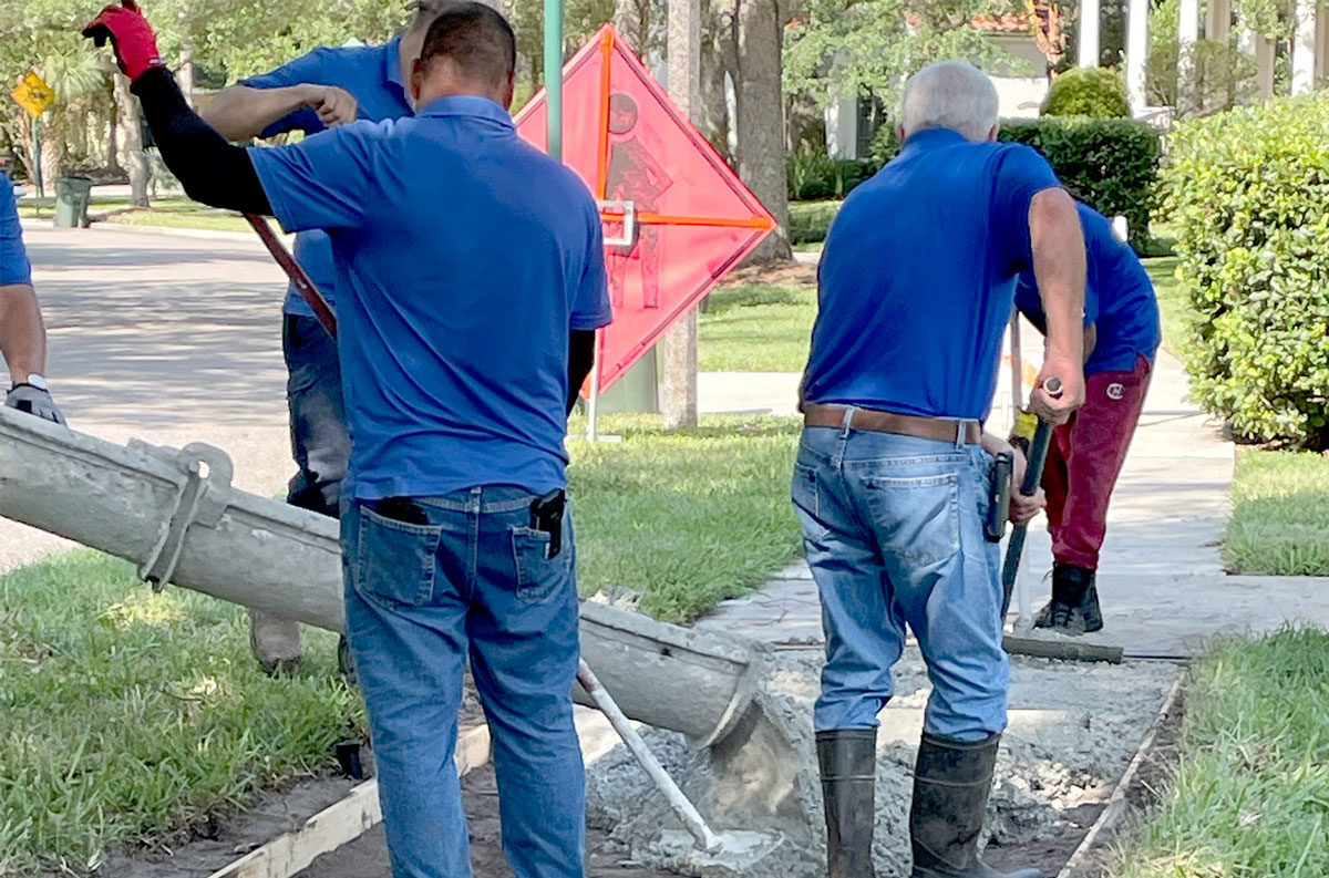 Maintenance Service Workers Fixing Pot Hole