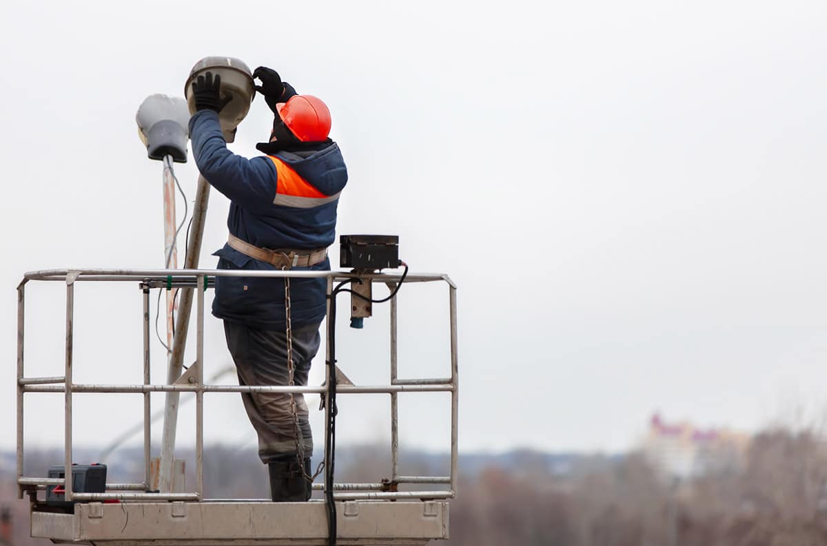 maintenance worker changing street light