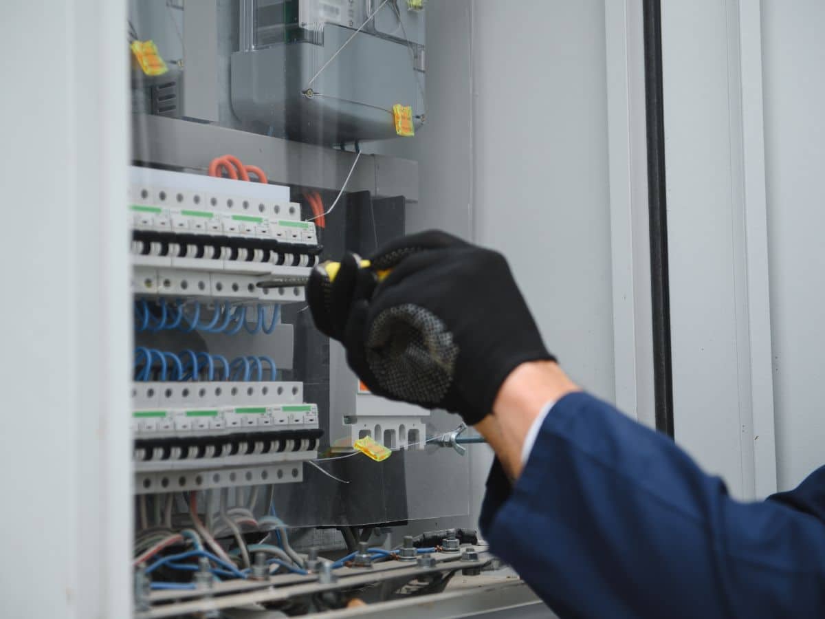 maintenance worker hand fixing breaker