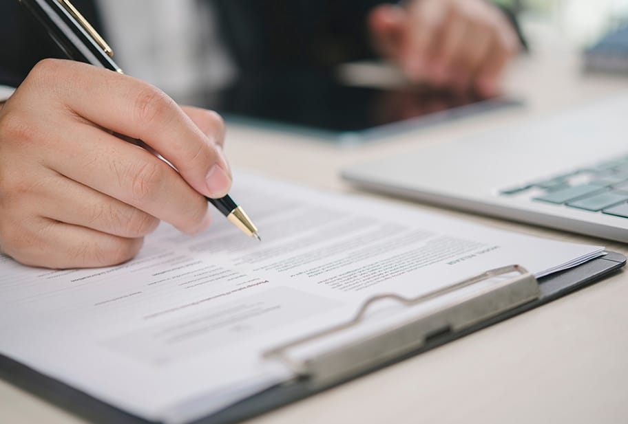 male client signing insurance papers
