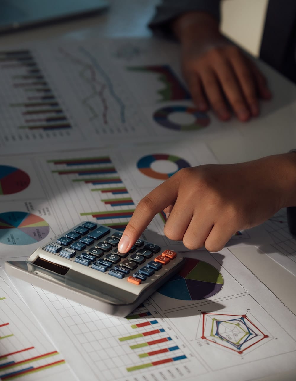 man calculating data and graphs