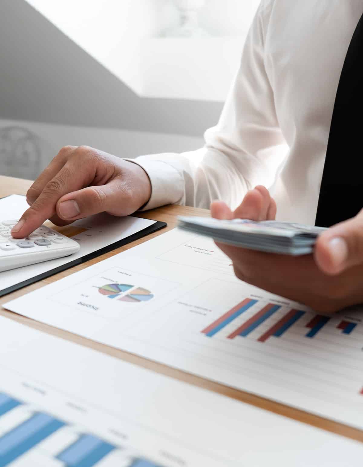 man calculating finances on reporting