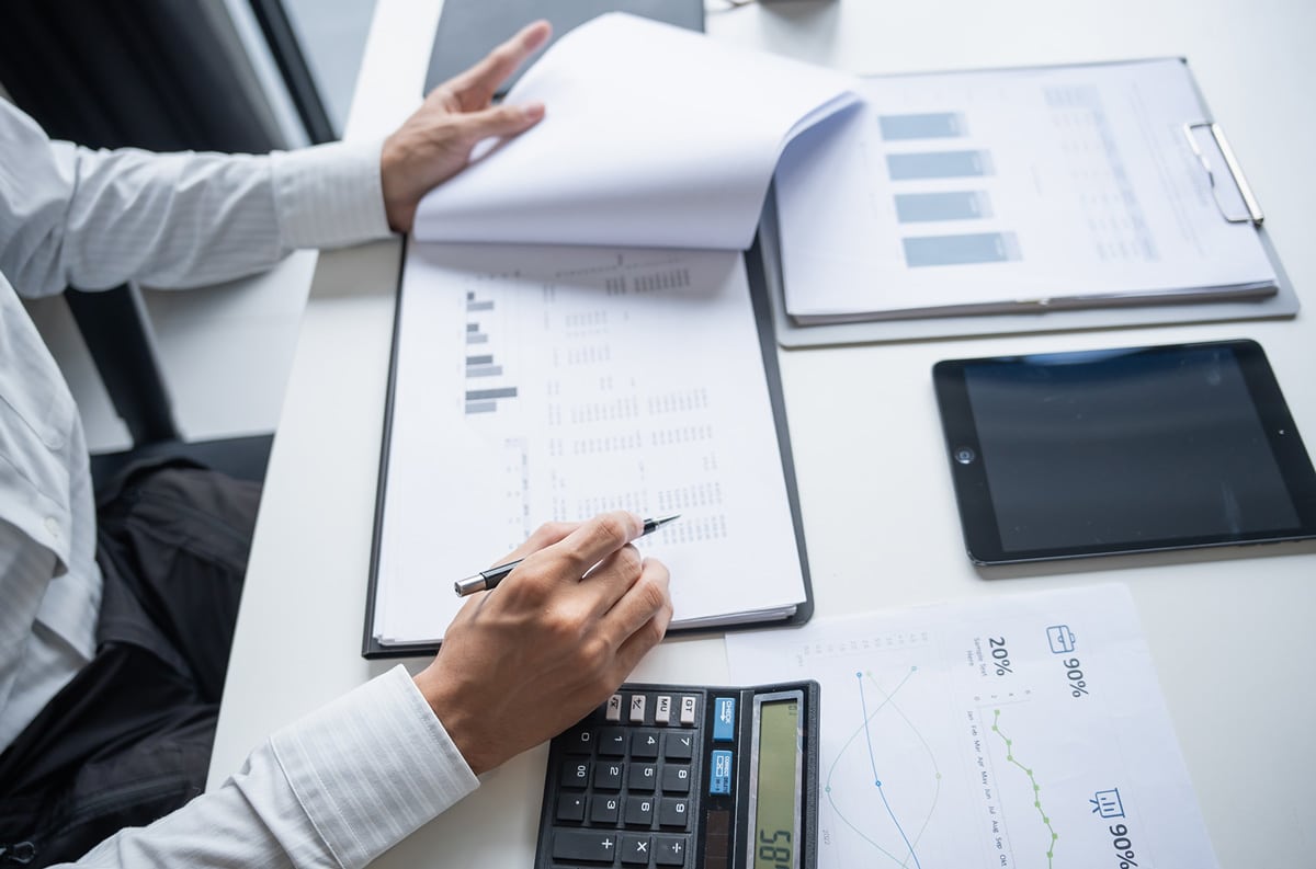 man financial auditor going over documents