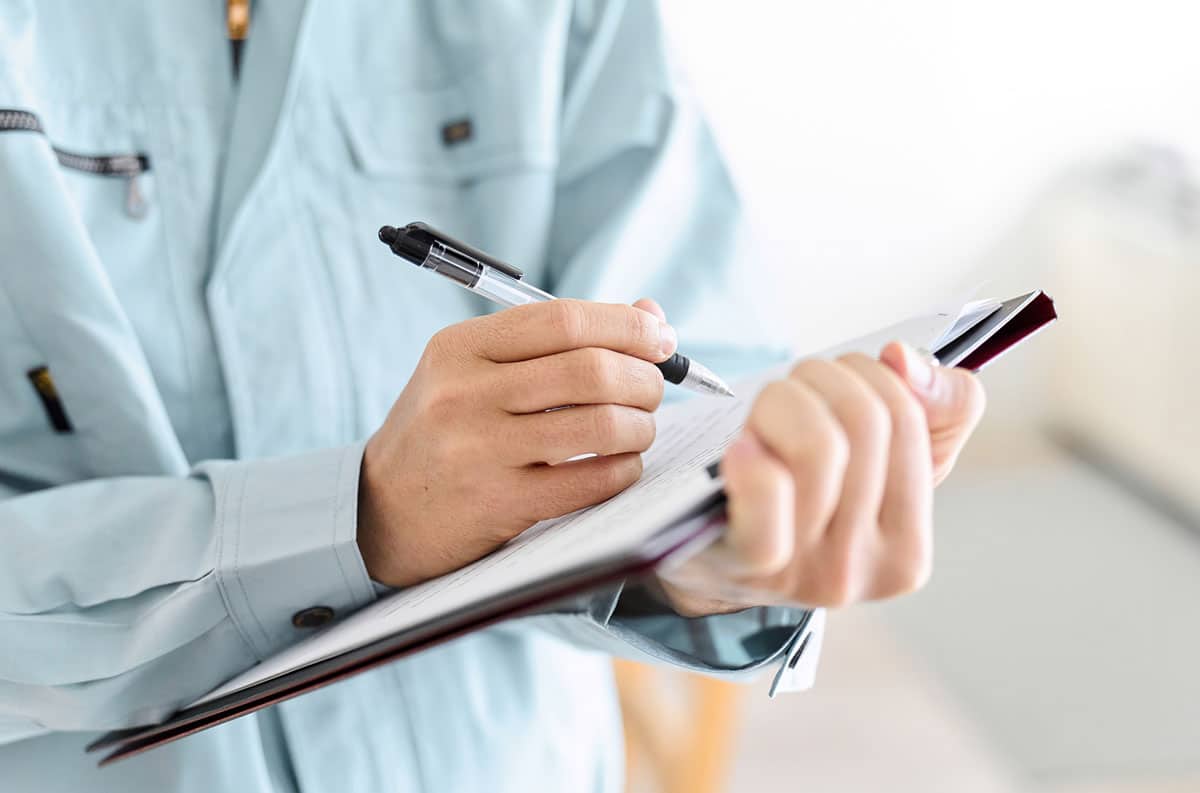 man holding clipboard inspection