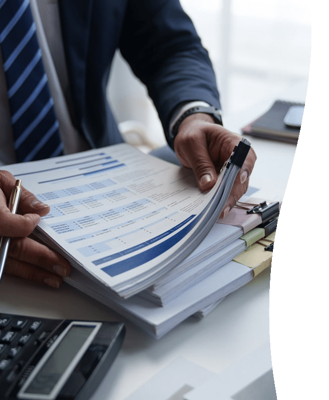 man holding piles of financial audit paperwork curve