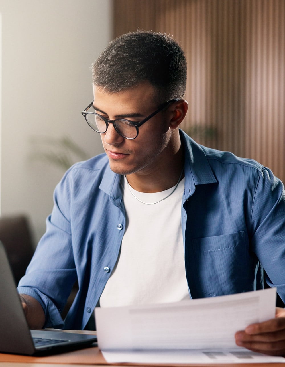 man looking at financial report anddata