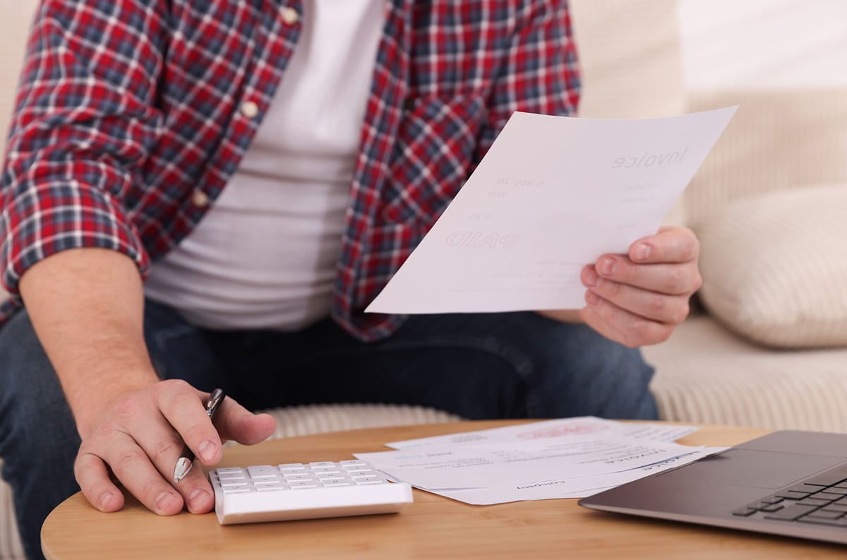 man looking over invoice