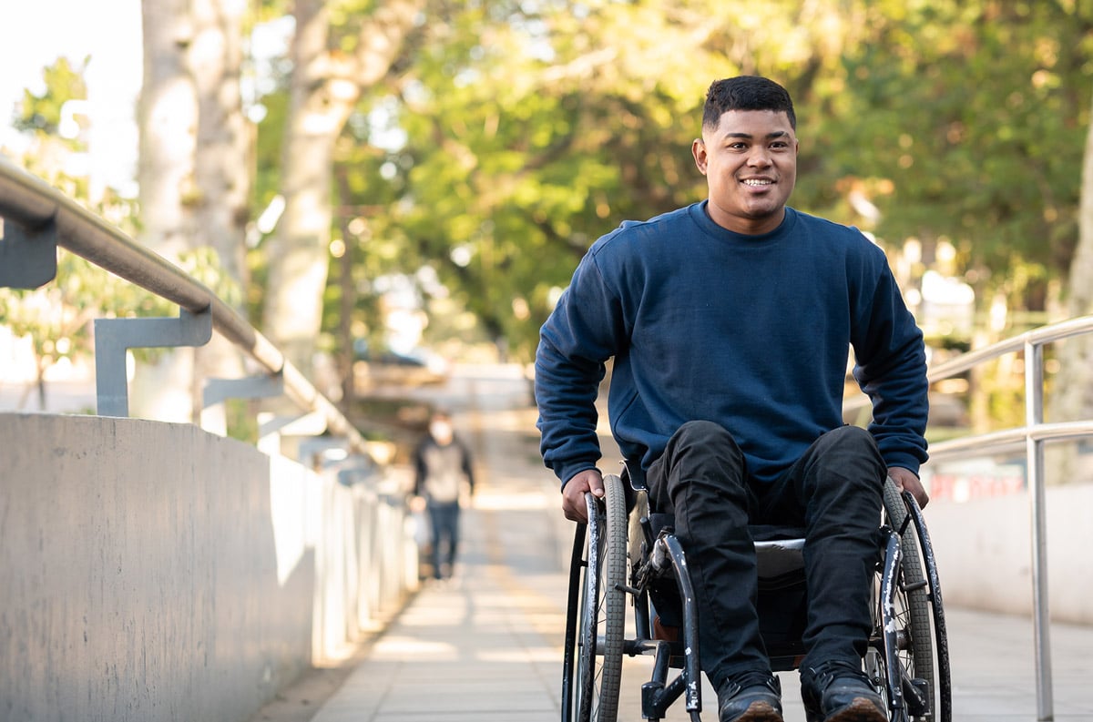 man on wheelchair in neighborhood