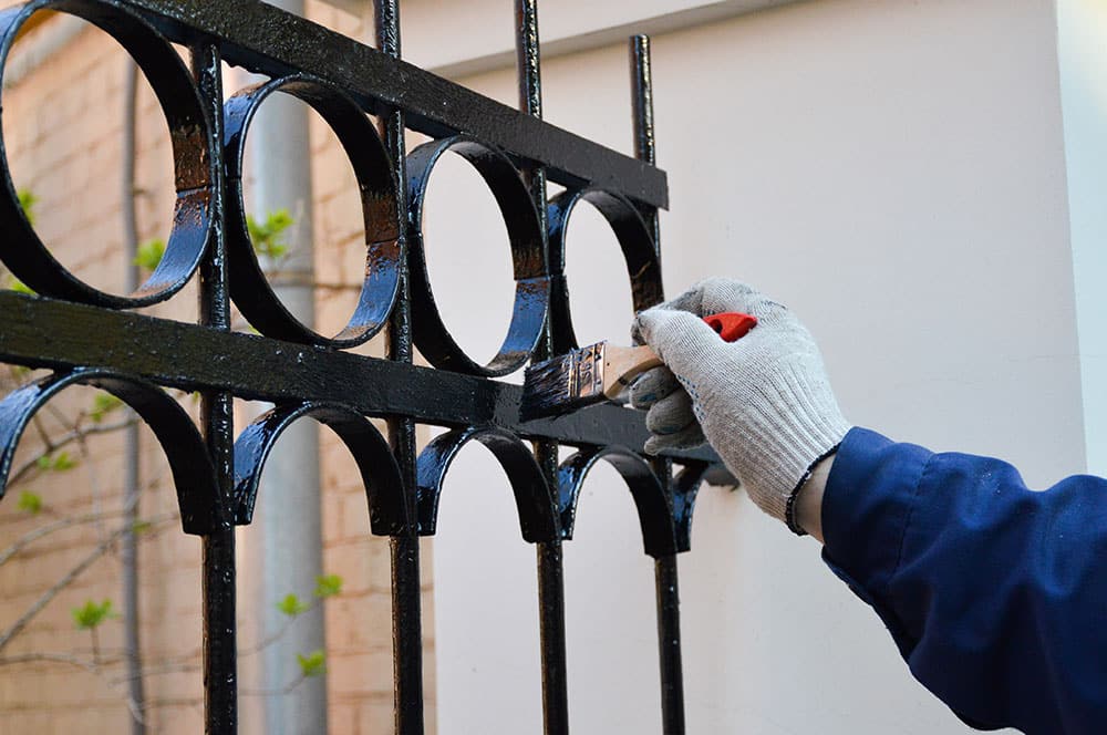 man painting fence
