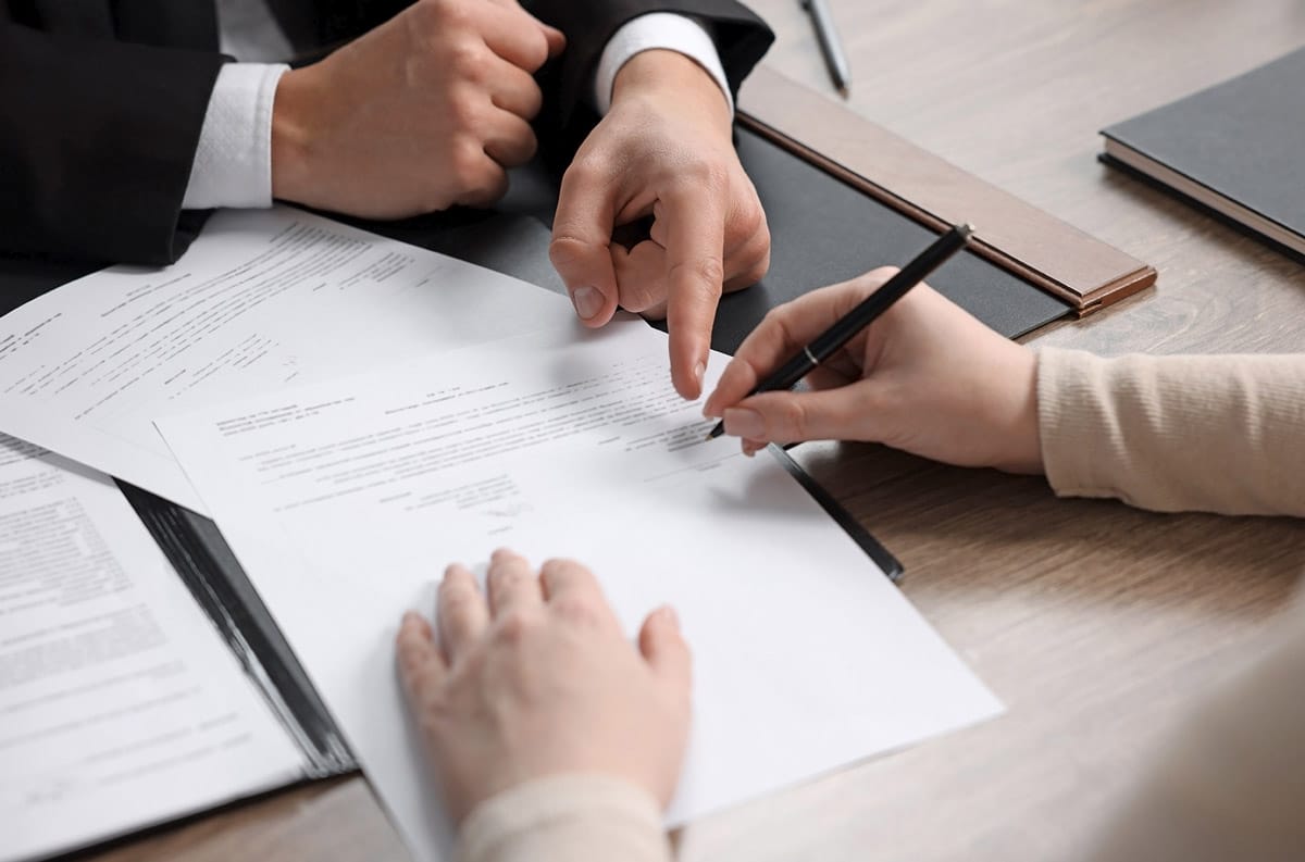 man signing work order document