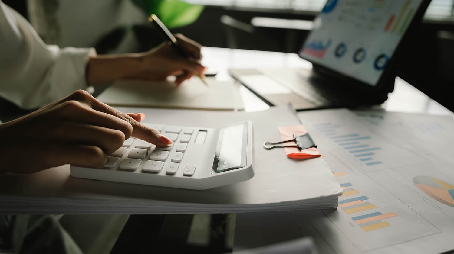 man using calculator for finance documents