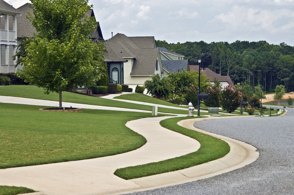 Manicured lawns and curving sidewalks in a modern neighborhood