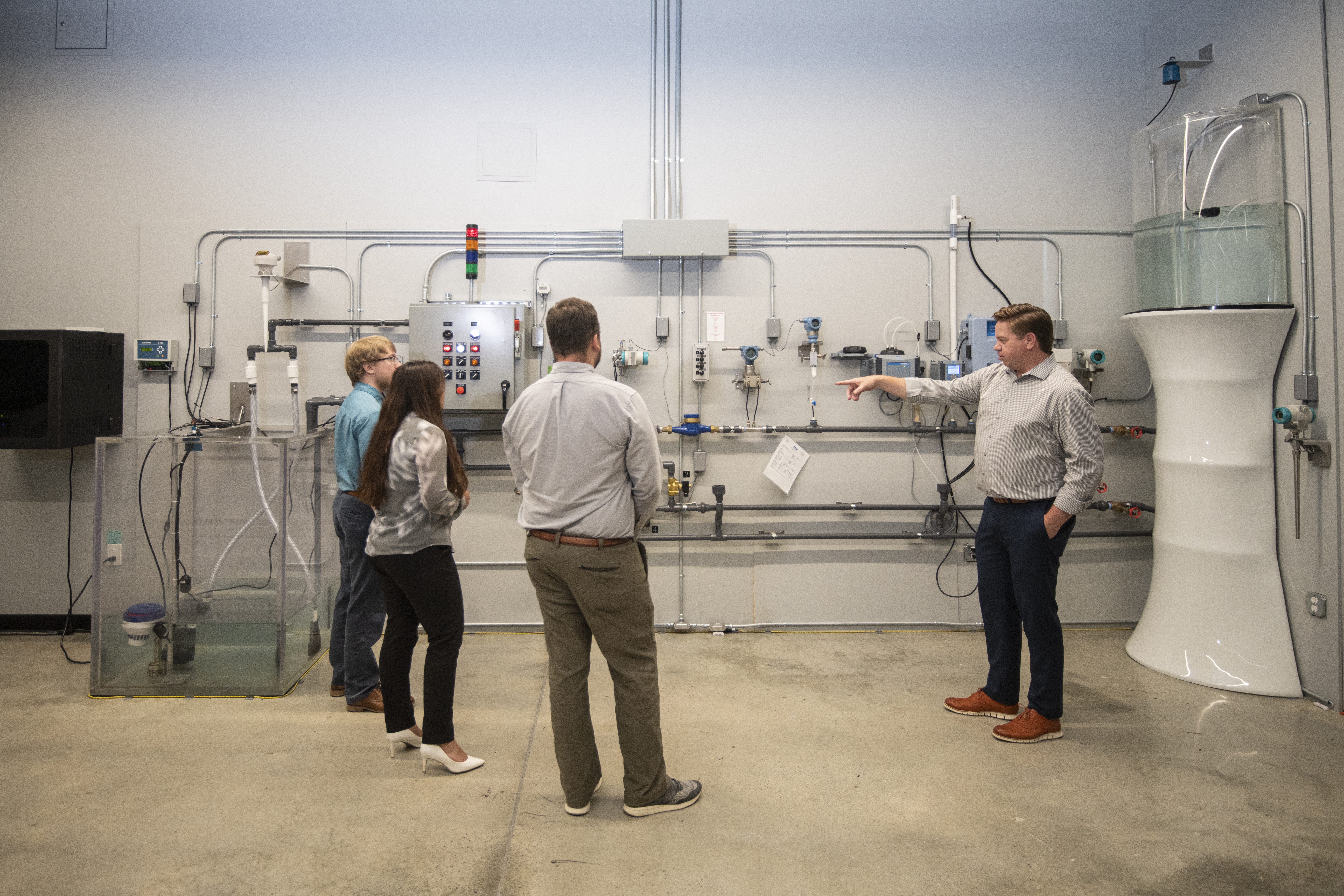 MR Systems team standing in front of industrial control equipment