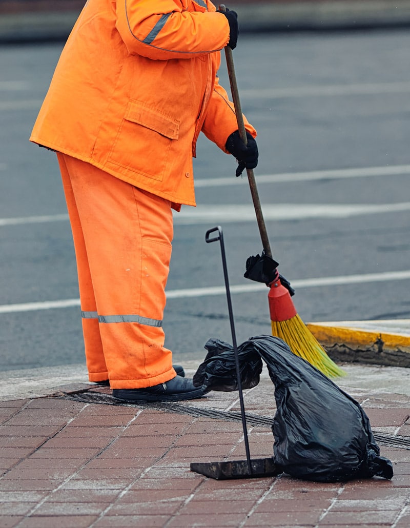 municipal porter employee sweeping road