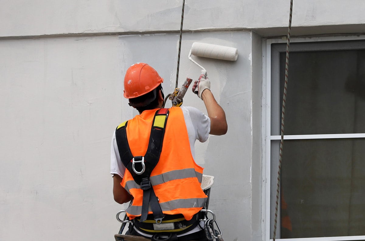 painter painting house exterior walls