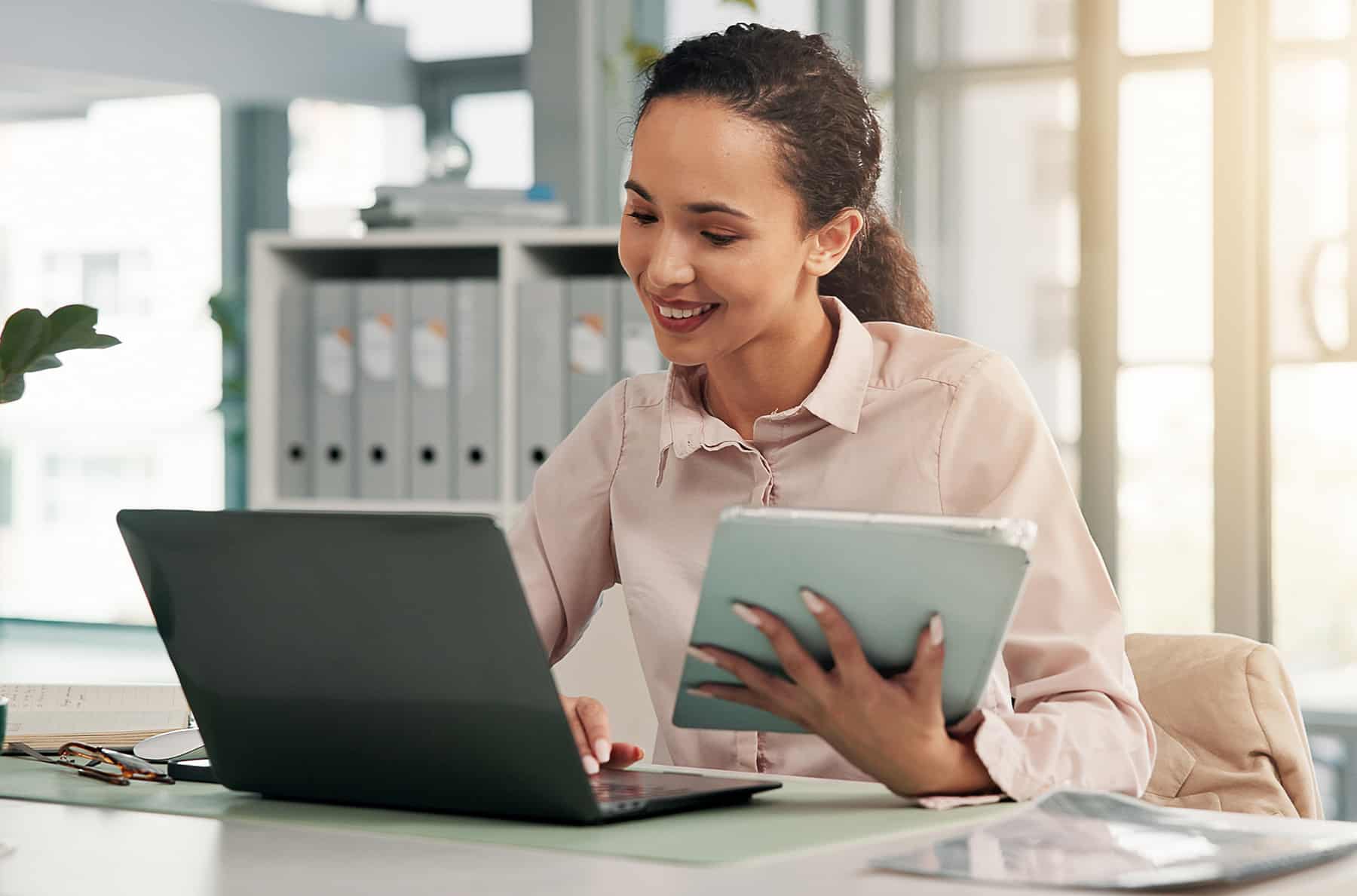 records manager smiling holding tablet
