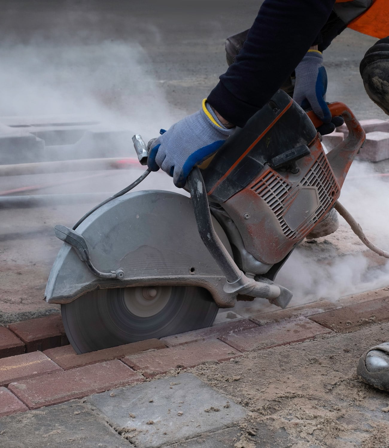 road maintenance worker grinding neighborhood sidewalk