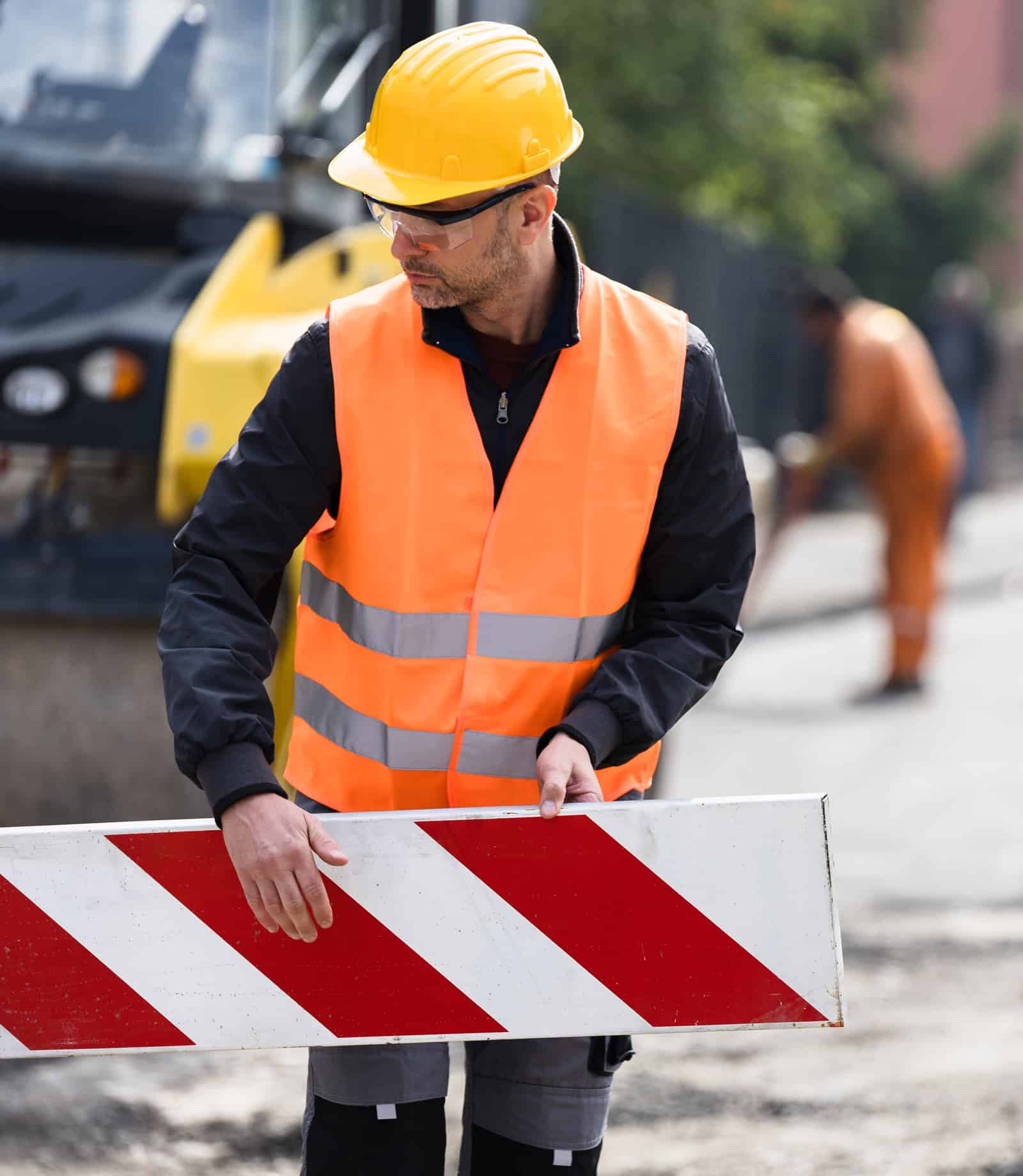 road maintenance worker setting traffic sign