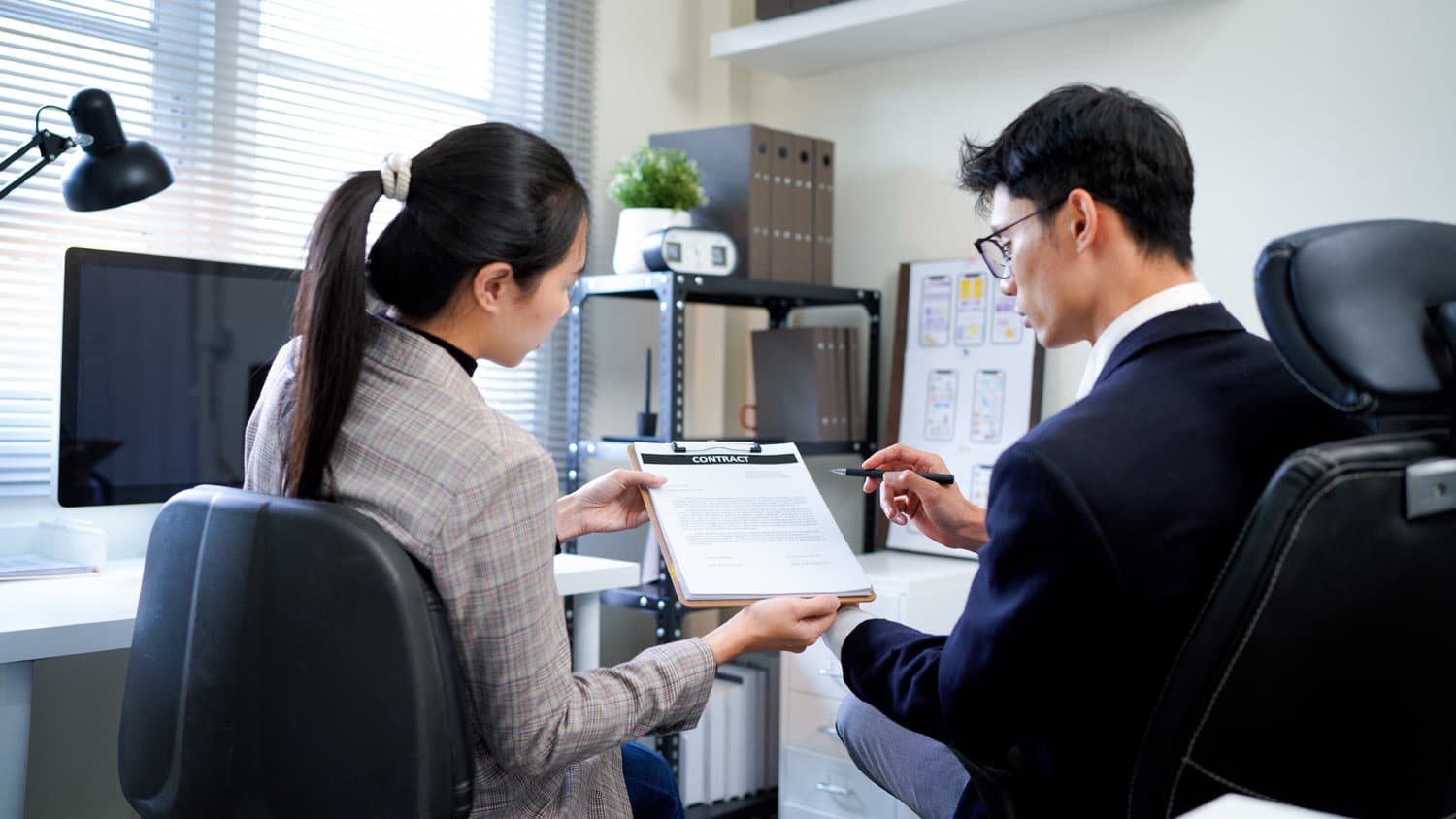 team reviewing vendor contract invoice binder