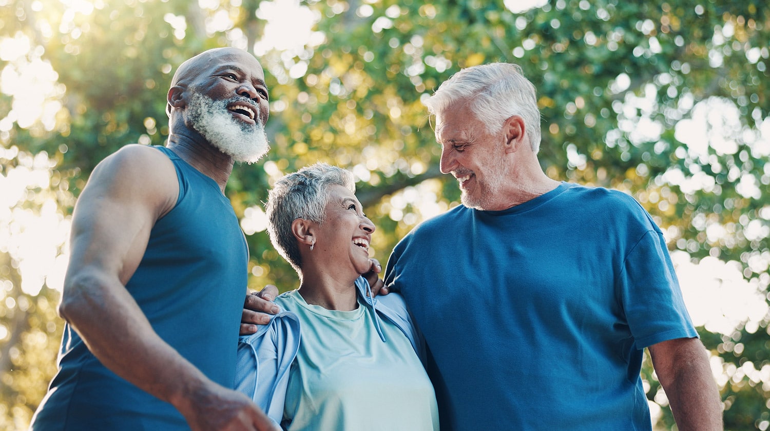 three elderly community residents smiling